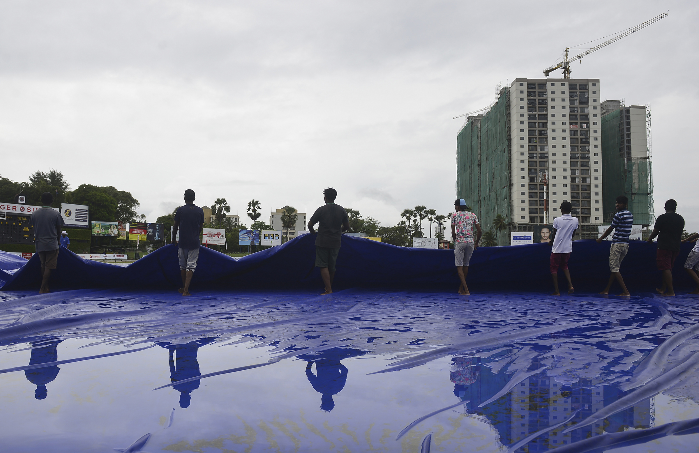 Karunaratne stands tall on downpour hit opening day